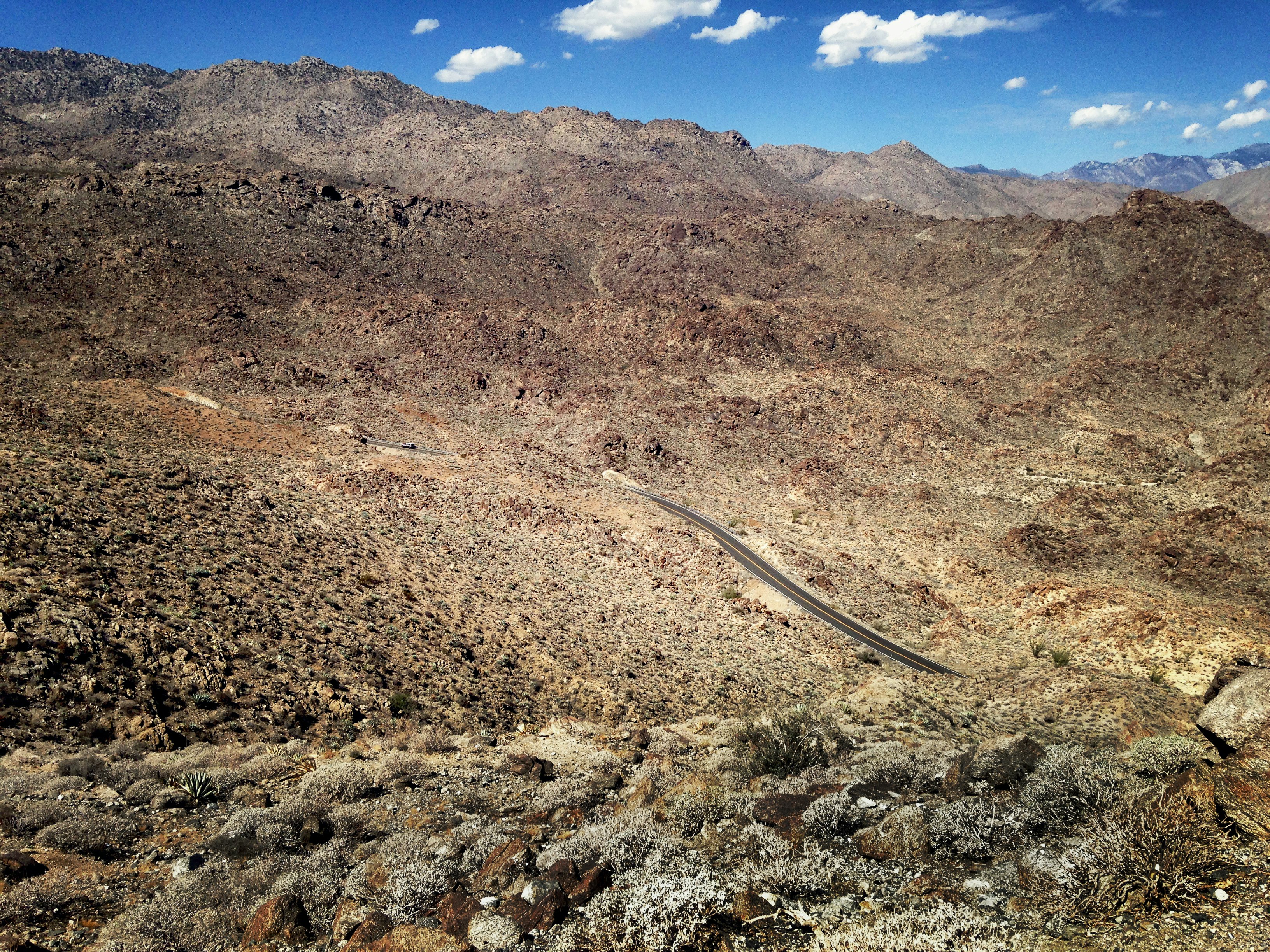 aerial photography of winding road on brown mountain